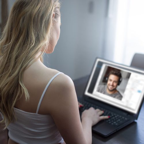 Young blonde woman dating online with handsome man, virtual dating